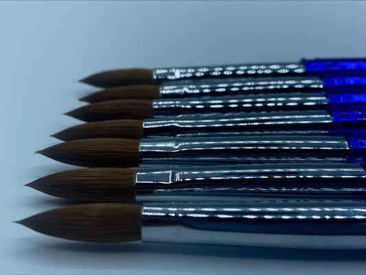 Close up of size 12 Kolinsky acrylic brush featuring fine bristles for precise nail art application. 